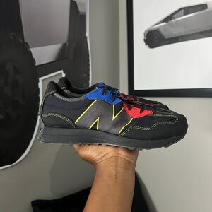 New Balance GS Black Sneakers with Blue and Red Details
